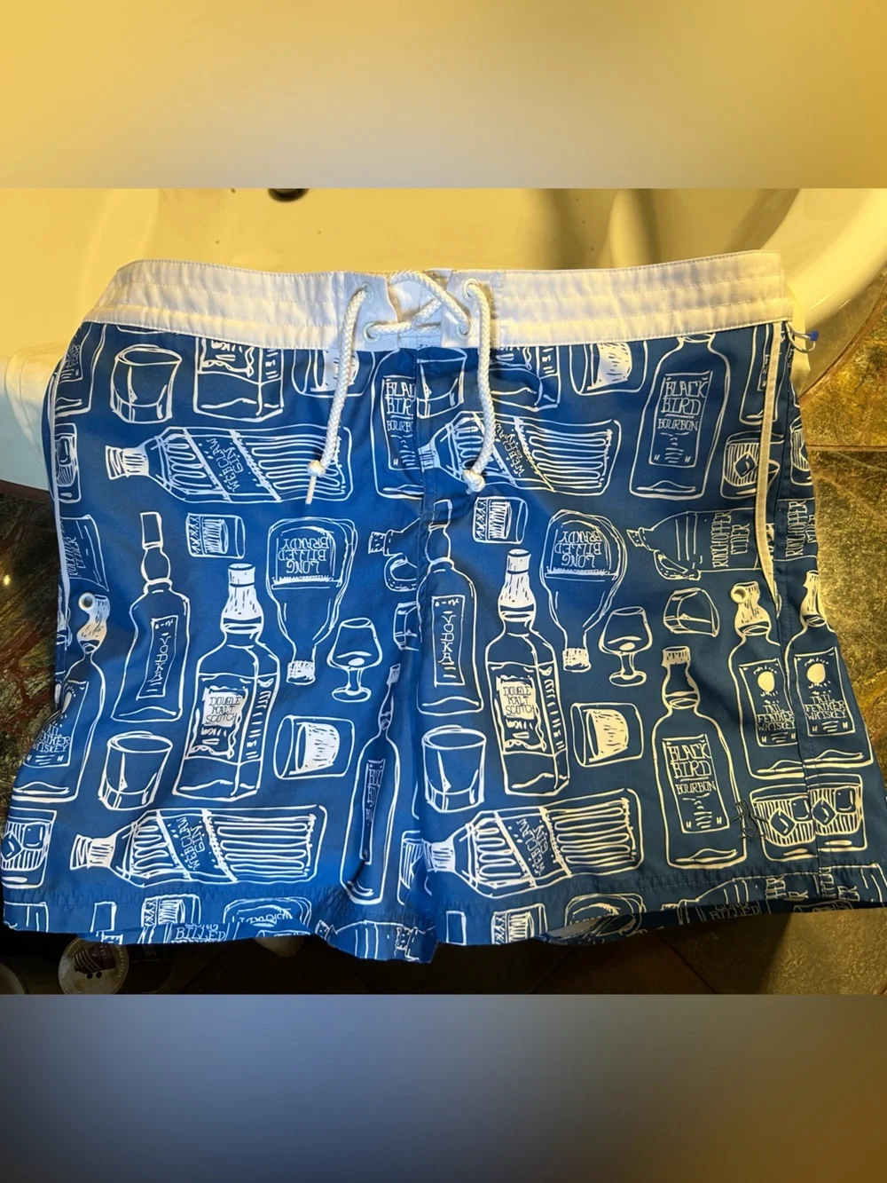 Penguin blue men’s swim trunk alcohol bottles, size 34